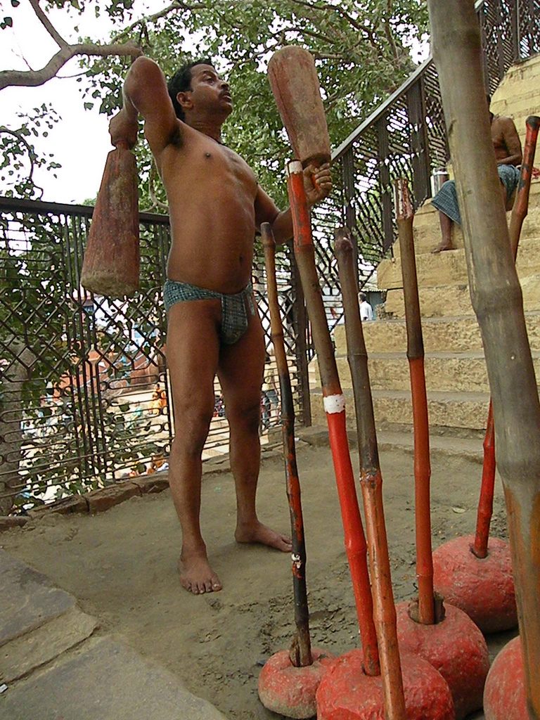 A young wrestler training on the earth of a traditional Indian akhada